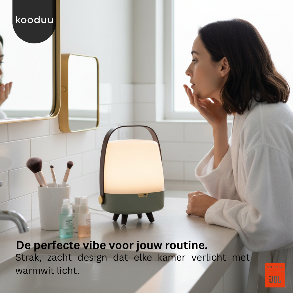 Woman in a bathroom with a lamp on the counter, surrounded by beauty products.