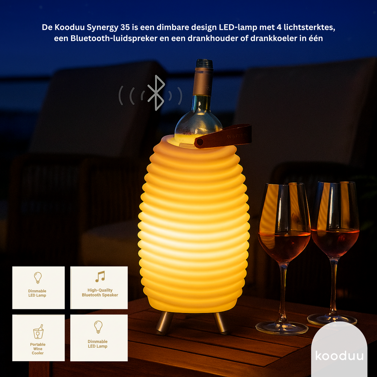 Kooduu Synergy 35 LED lamp with Bluetooth speaker and drink holder on a table with wine glasses.