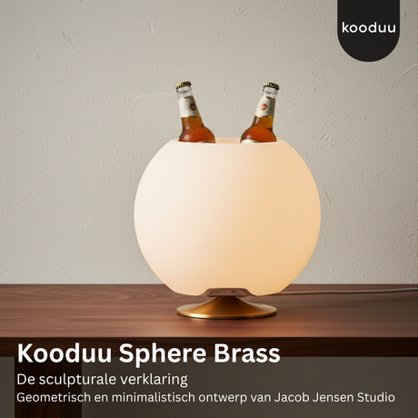 Kooduu Sphere Brass lamp with two bottles on a wooden surface and gray background