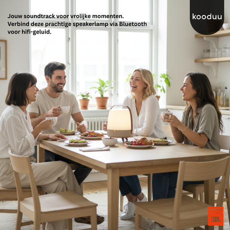 People sitting around a table with a speaker lamp, featuring the brand 'kooduu'.