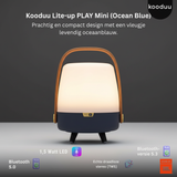 Kooduu Lite-up PLAY Mini lamp with ocean blue base and wooden handle on a gray background