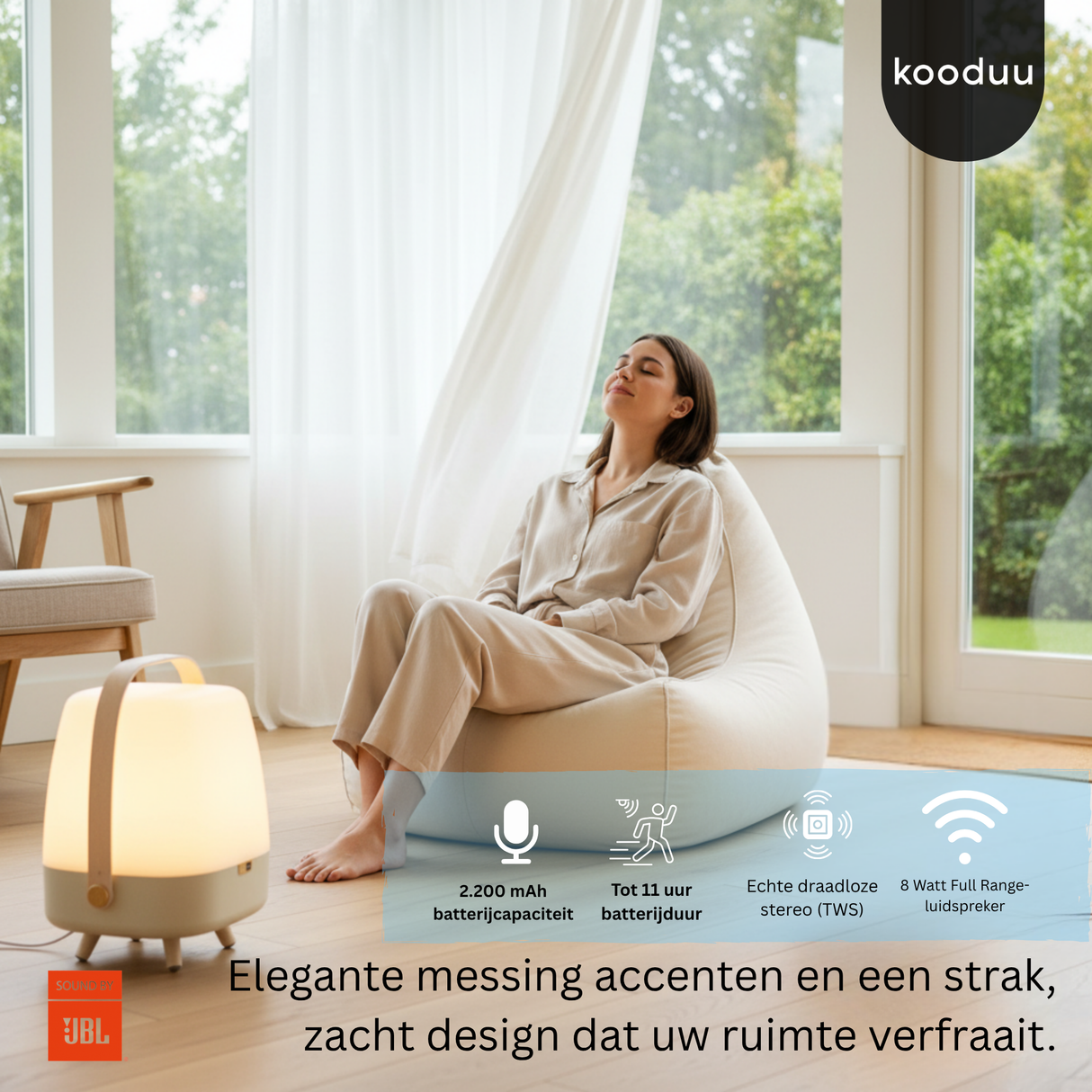 Woman sitting in a bean bag chair with a lamp next to her, in a bright room with large windows.