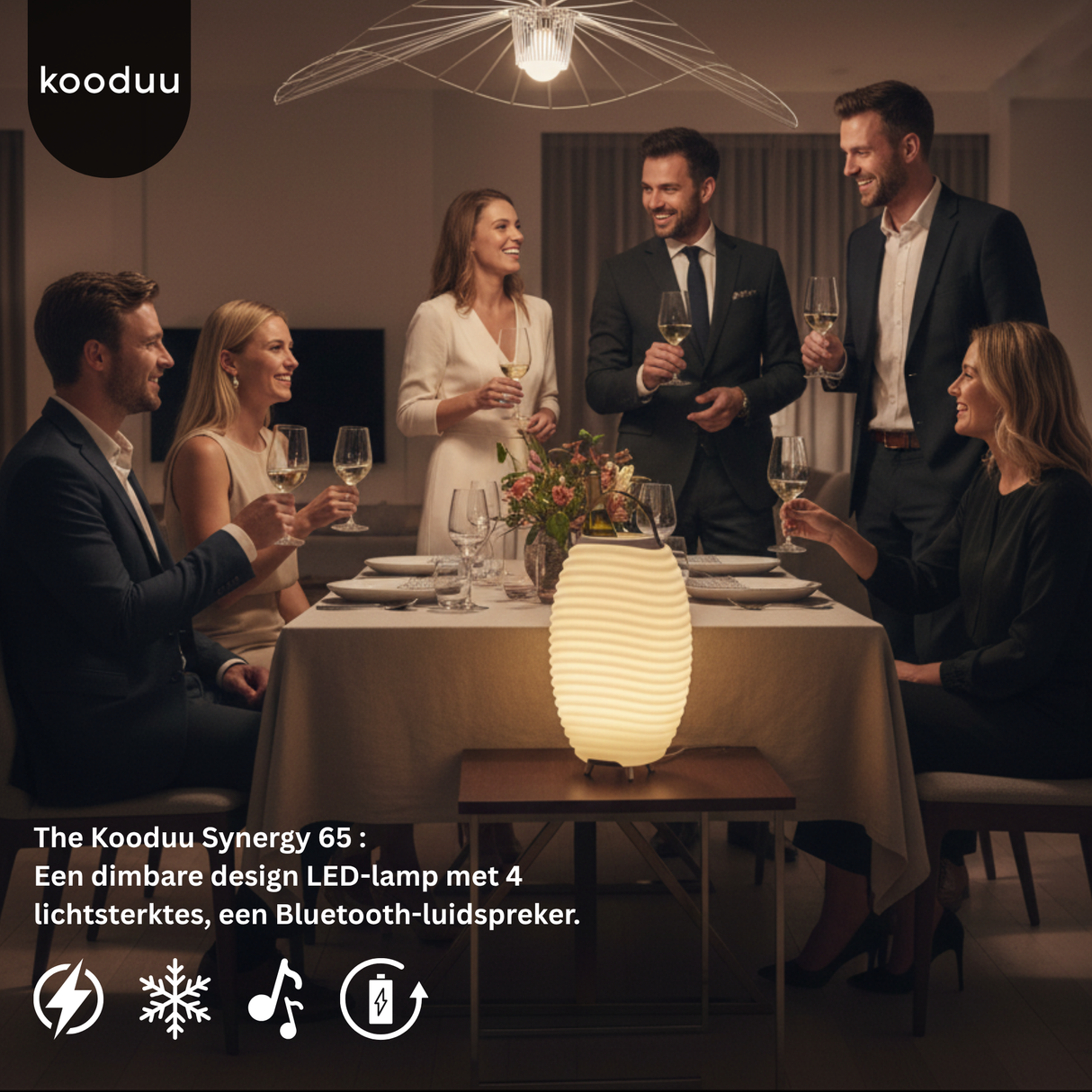 Group of people enjoying a dinner party with a Kooduu Synergy 65 lamp on the table.